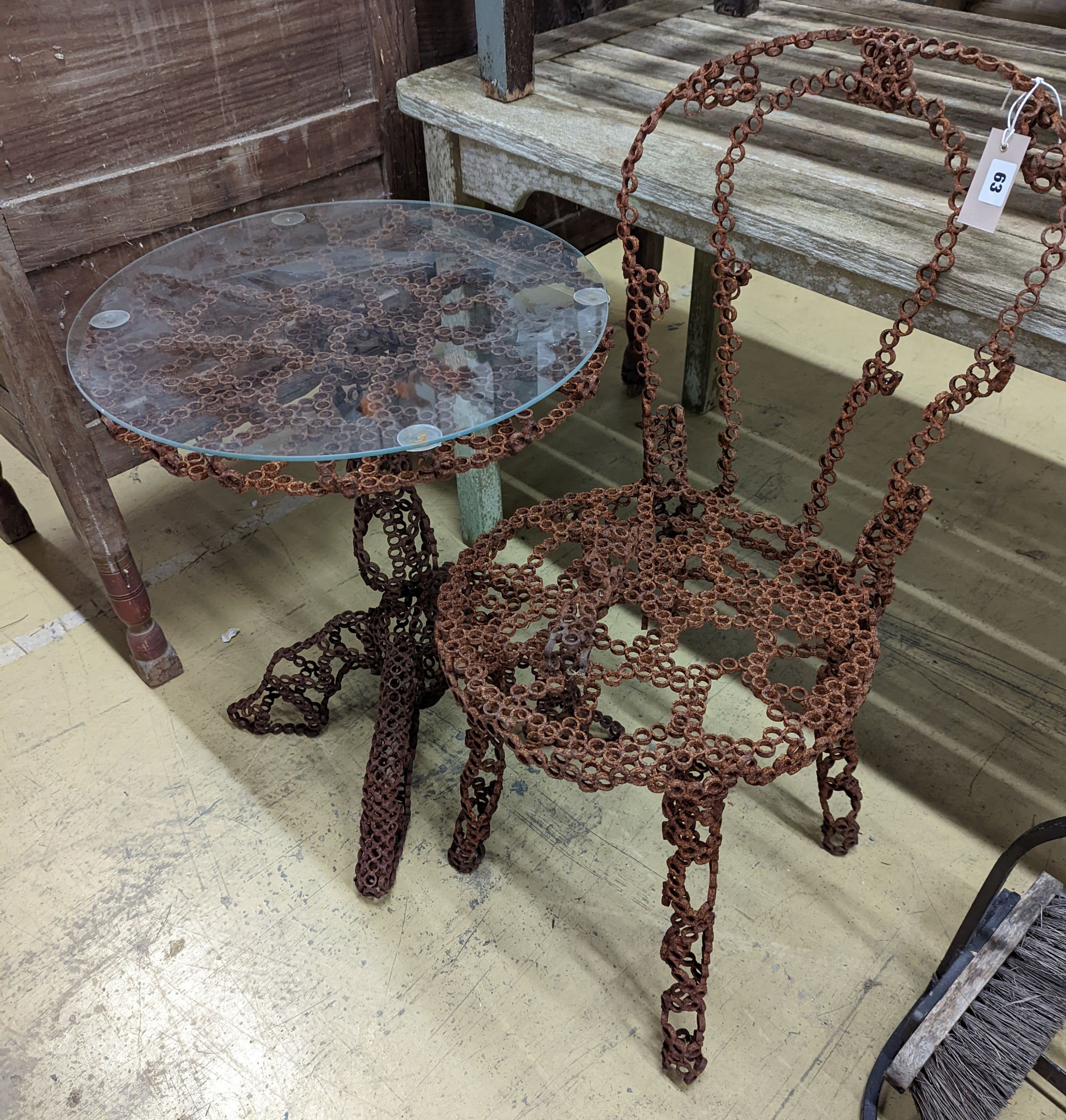 A reclaimed metal table and chair (chair a.f.) table measurements, D-54cm, H-66cm.
